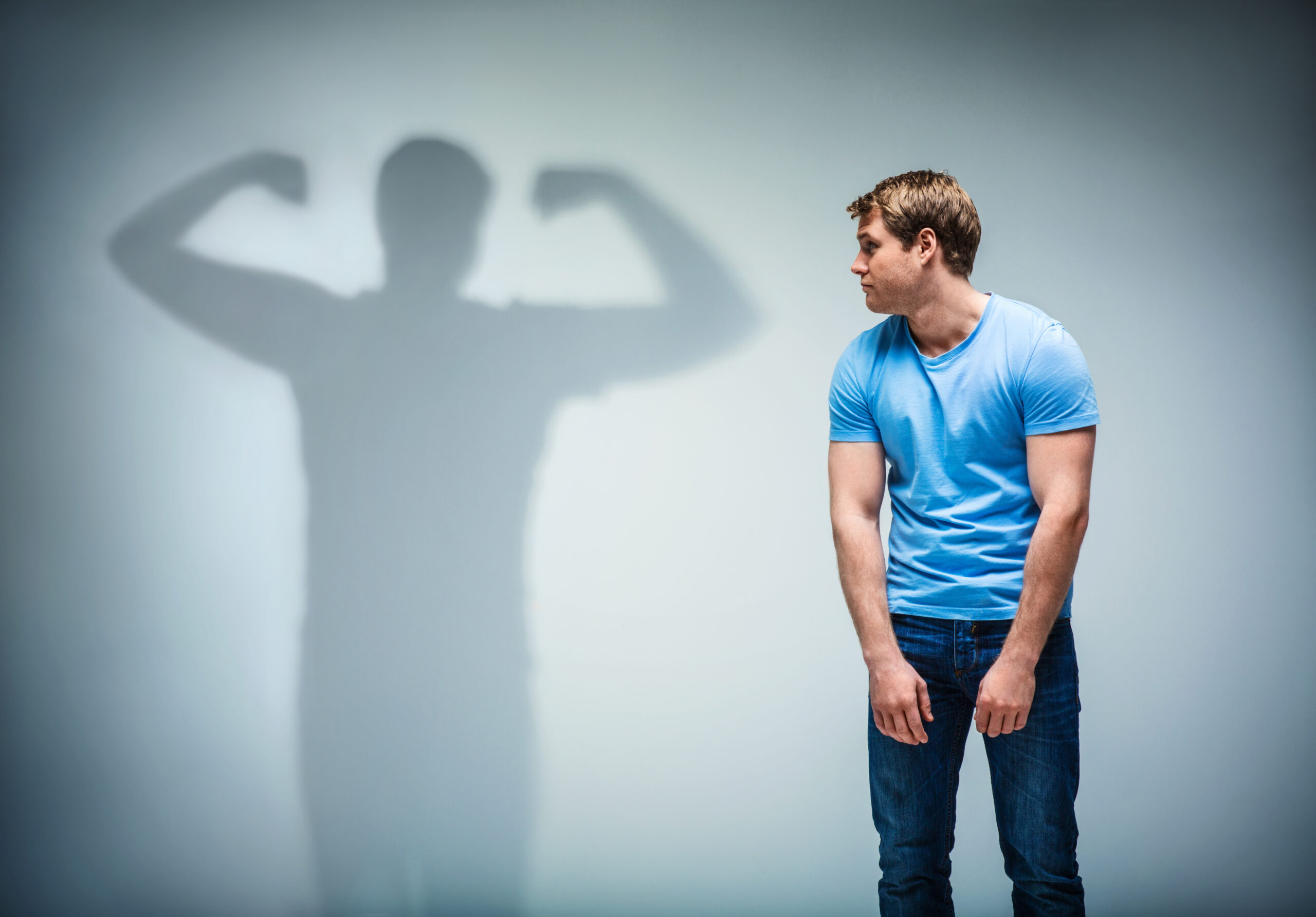 Man facing a large shadow silhouette